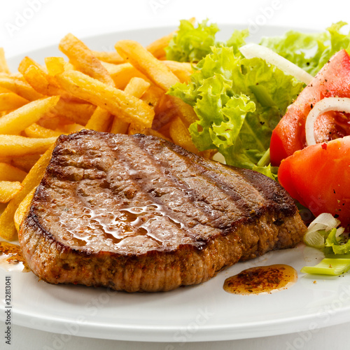 Photo: Grilled steak, French fries and vegetables Grilled steak, French fries and vegetables