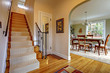 Hallway with large staircase and dinign room