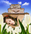 Photo: Traveling young woman resting in a tulip field Traveling young woman resting in a tulip field