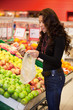 Young woman buying fruits