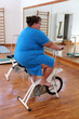 Foto: overweight woman exercising on bike overweight woman exercising on bike