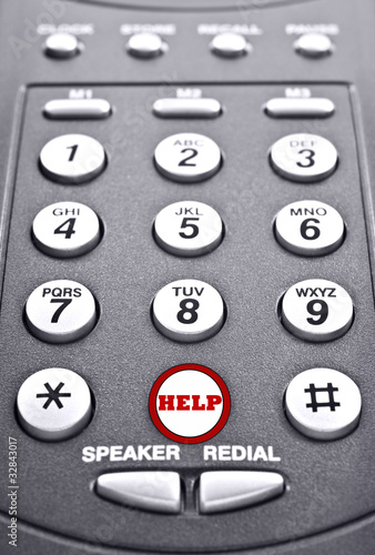Photo: Keypad of a telephone with a red button for help Keypad of a telephone with a red button for help
