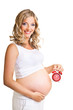 Pregnant woman with clock isolated on white