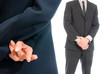 Business concept fingers crossed in front of boss isolated