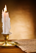 Photo: copy space view on the ablaze candle and old notes copy space view on the ablaze candle and old notes