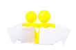 Two toy little men stand near  arrows specifying a direction.