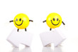 Two  toy little men stand near the arrows specifying a direction