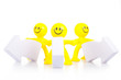 Three toy  men stand near the arrows specifying a direction.
