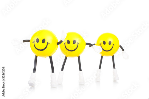 Photo: Three smiling toy little men on a white background Three smiling toy little men on a white background