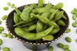 Edamame soy beans in a brown ceramic dish