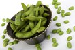 Edamame soy beans in a brown ceramic dish