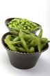 Edamame soy beans in a brown ceramic dish
