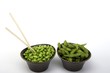 Edamame soy beans in a brown ceramic dish