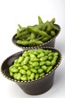 Edamame soy beans in a brown ceramic dish
