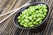 Edamame soy beans in a brown ceramic dish