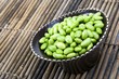 Edamame soy beans in a brown ceramic dish