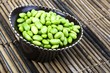 Edamame soy beans in a brown ceramic dish