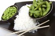 Edamame soy beans with white rice in a brown ceramic dish
