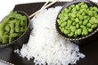 Edamame soy beans with white rice in a brown ceramic dish