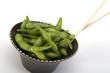 Edamame soy beans in a brown ceramic dish