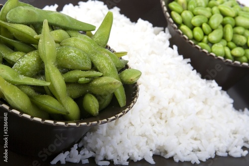 Photo: Edamame soy beans with white rice in a brown ceramic dish Edamame soy beans with white rice in a brown ceramic dish