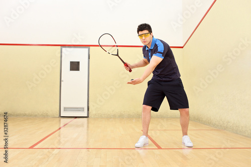 Photo: Squash player serving a ball Squash player serving a ball
