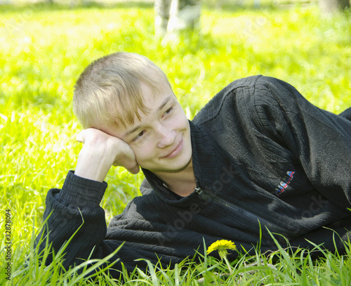 Photo: boy lying on green boy lying on green