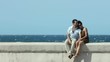 young husband and wife during afternoon walk near the sea