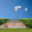 An Overgrown Wall with Balustrade and Blue Sky An Overgrown Wall with Balustrade and Blue Sky