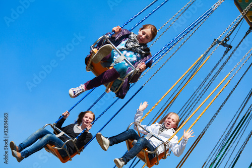 Photo: Teenage girls on the chain swing carousel Teenage girls on the chain swing carousel