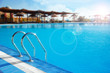 Swimming pool with stair lit by sunlight Swimming pool with stair lit by sunlight