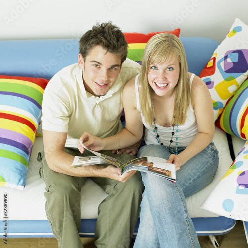Photo: couple sitting on sofa couple sitting on sofa