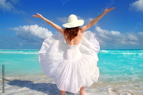 Photo: beach rear woman wind shaking white dress beach rear woman wind shaking white dress