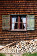 Ancient window on log house wooden wall