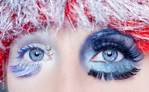 Photo: christmas concept eye makeup winter red silver macro christmas concept eye makeup winter red silver macro