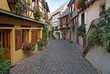 Narrow street with old houses, small european town, France Narrow street with old houses, small european town, France