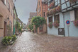 Old European rainy cobbled street, Alsace, France