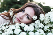 Beautiful young woman near blossom bush Beautiful young woman near blossom bush