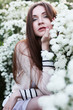 Beautiful young woman near blossom bush Beautiful young woman near blossom bush
