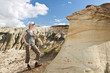 Hiker in badlands of Alberta, Canada