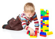 a funny boy is playing with lego