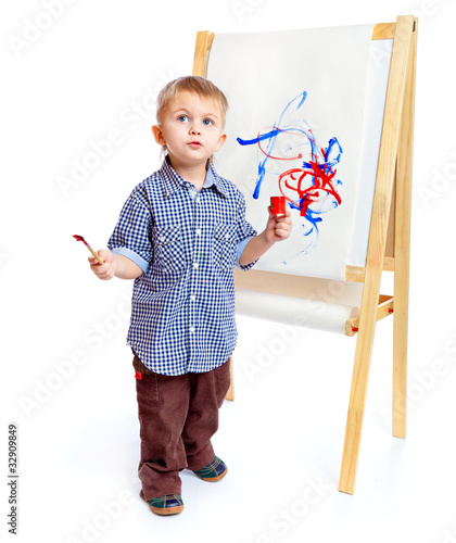 Photo: A boy is drawing on a blackboard. Isolated on a white background A boy is drawing on a blackboard. Isolated on a white background
