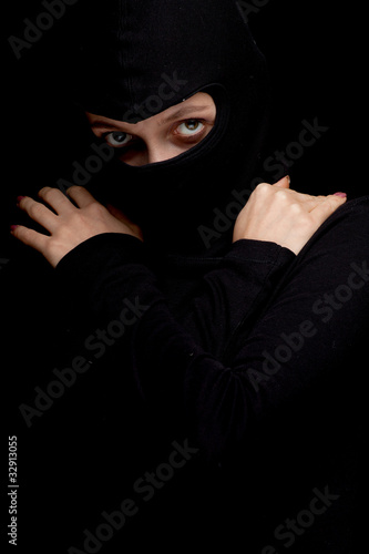 Photo: female thief in black clothes and balaclava female thief in black clothes and balaclava