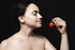 Photo: woman with naked shoulders and chest holding red strawberry woman with naked shoulders and chest holding red strawberry
