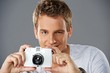 Portrait of a young man with a camera