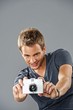 Young handsome man with a camera
