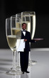Waiter standing near champagne glasses