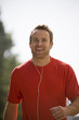 A young man jogging, listening to music