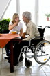 Foto: Carer feeding Disabled Woman Carer feeding Disabled Woman