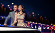 Elegant couple traveling a limousine at night
